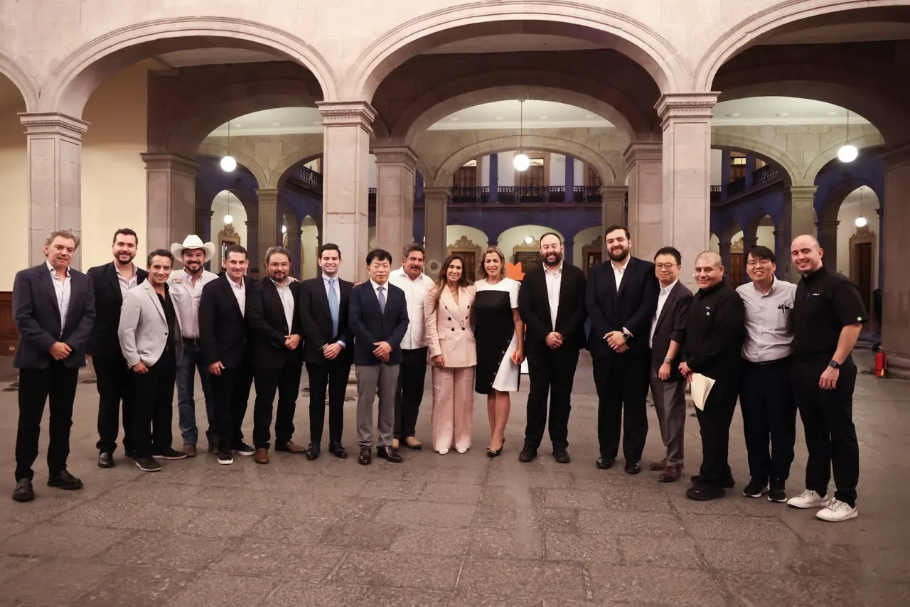 Government officials and Kia executives in the courtyard of the Government Palace of Nuevo León after the EV3 unveiling